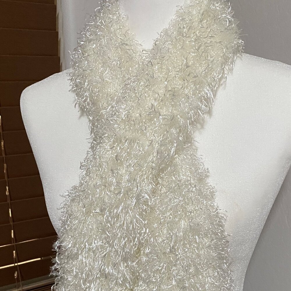 Fuzzy white-colored scarf.